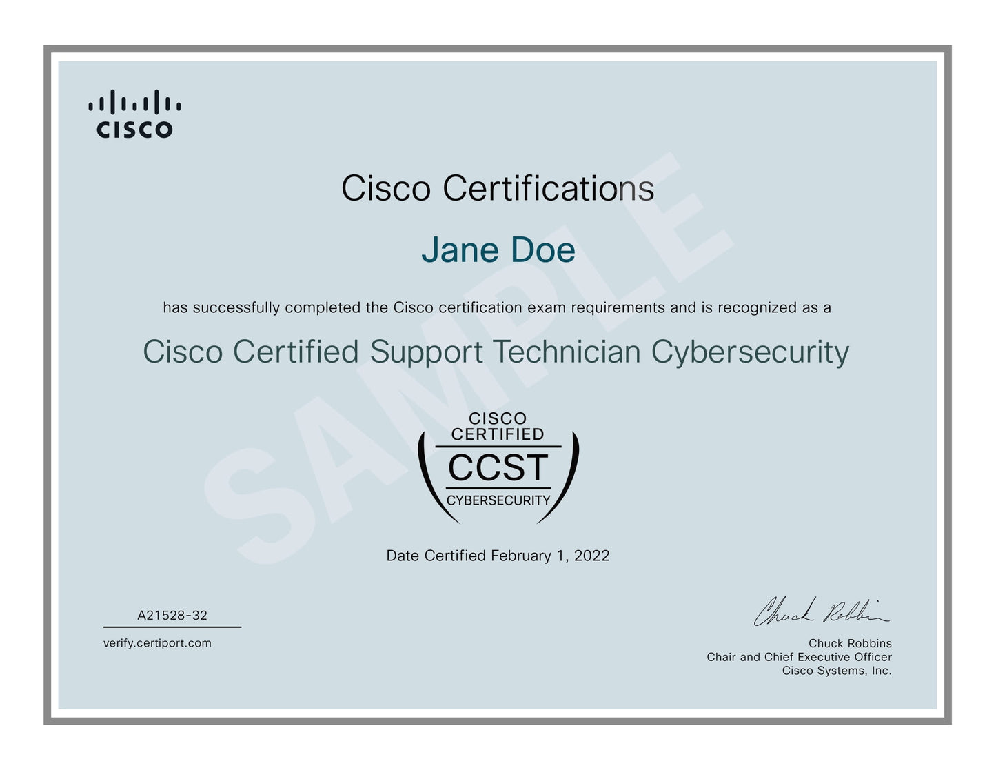 Sample Cisco Certified Support Technician Cybersecurity certificate awarded to 'Jane Doe' by Cisco, dated February 1, 2022, signed by Chuck Robbins, Chair and CEO of Cisco Systems, Inc. The certificate confirms successful completion of Cisco certification exam requirements, includes the Cisco logo, CCST Cybersecurity emblem, certificate ID (A21528-32), and verification link (verify.certiport.com), on a light blue background with a gray border.